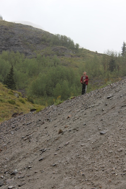 Kids willingly hike up in in downpour to escape camp chores.