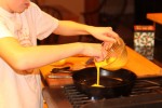 Charlie cooks eggs